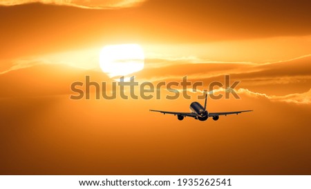 Plane is taking off at sunset.