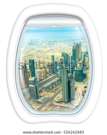 Plane window on skyscrapers of Dubai downtown skyline on Sheikh Zayed Road, United Arab Emirates, from a plane through the porthole. Copy space.