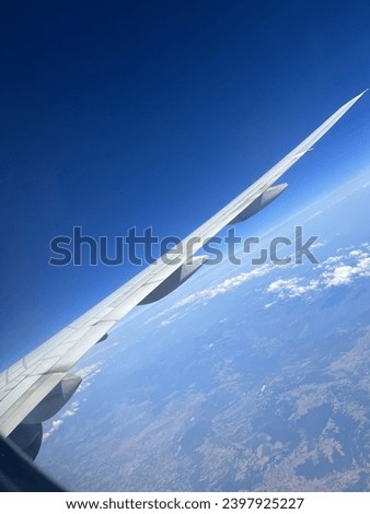 Plane window view of sky