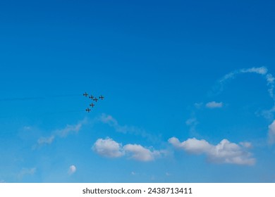 Planes flying in formation as part of an Aerobatic airshow  - Powered by Shutterstock