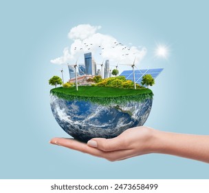 Planet earth with clean modern city relying on renewable resources. Environmental concept of alternative sustainable energy for an eco-friendly planet. Planet earth used with permission from NASA.