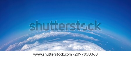 Planet Earth Curvature. Aerial shot. Blue cloudy sky over land. Space, science concept