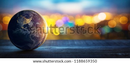 Planet Earth on the background of blurred lights of the city. Concept on business, politics, ecology and media. Earth day abstract background. 