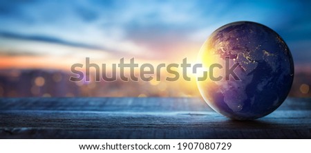 Planet Earth on the background of blurred lights of the city. Concept on business, politics, ecology and media. Earth day abstract background. Elements of this image furnished by NASA