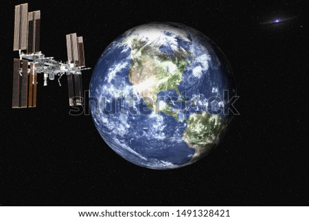 Planet Earth with satelite space station of solar system in the space with far galaxy on the background. Blue planet.  Science fiction. Elements of this image were furnished by NASA