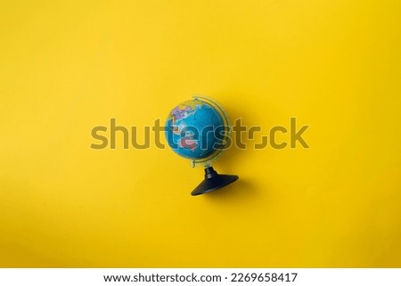 planet earth school globe on pastel background, concept of studying in school