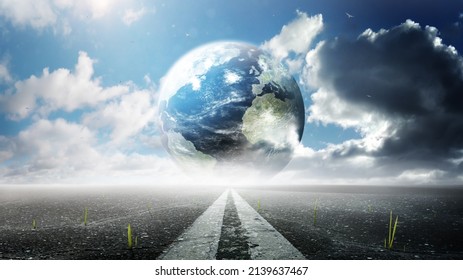 Planet Earth. Planet Stands On The Road And Under A Clear Sky. Peace Concept. Close Up View From Asphalt Level. A Green Sprout Growing From Cracks In The Aspha