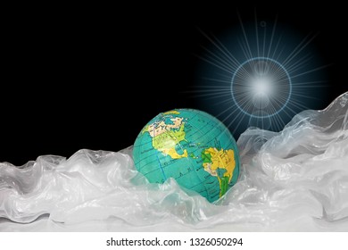 planet earth trapped in a sea of plastic waste that is bad for the environment with black background stock image stock photo - Powered by Shutterstock