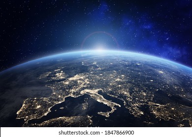 Planet Earth viewed from space with city lights in Europe. World with sunrise. Conceptual image for global business or European communication technology, elements from NASA