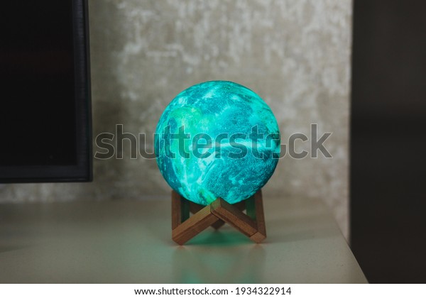 planet or moon lamp stands on the table. round\
night light