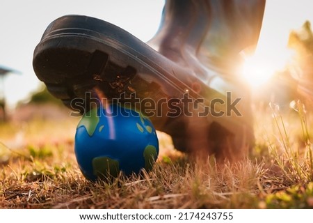 planet is under threat. The shoe presses on the layout of the planet earth. The concept of an ecological catastrophe. The destruction of the planet.