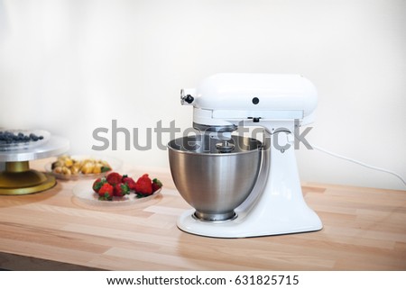 Planetary mixer on a table with fruit