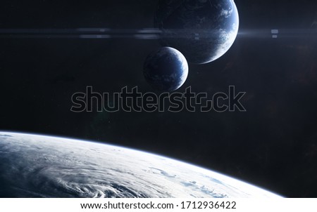 Planets somewhere in deep space in light of blue star. Science fiction. Elements of this image furnished by NASA