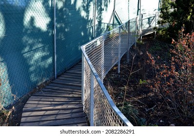 a plank walkway with stainless steel railings leads around the lake with rare ducks. the fence panel is made of rope fishing net. from the terrace of the plateau there are wonderful views of the lake.