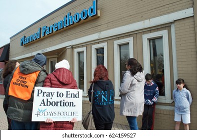 Planned Parenthood, Ferndale, Michigan, USA - March 24, 2017:  Planned Parenthood building with pro-life volunteers praying to end abortion, March 24, 2017, Ferndale, Michigan