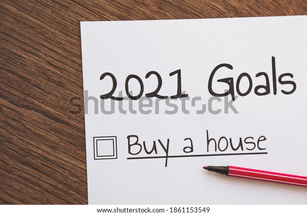 planner of\
goals and plans for 2021, a sheet of paper with the inscription buy\
a house from to do list, planning concept\
