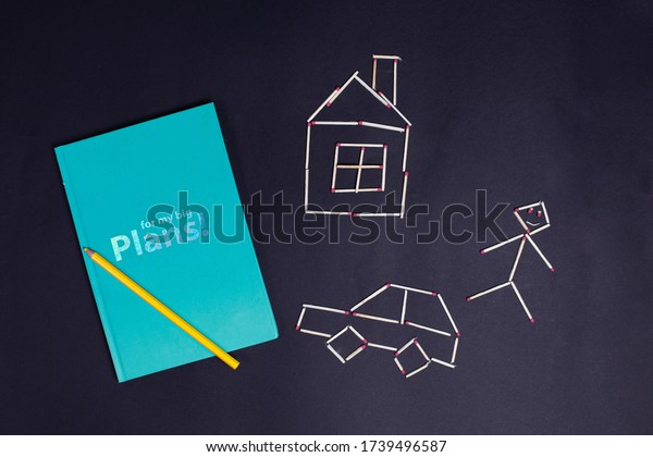 Planner notebook for kids with house, car and a man made\
of matches 