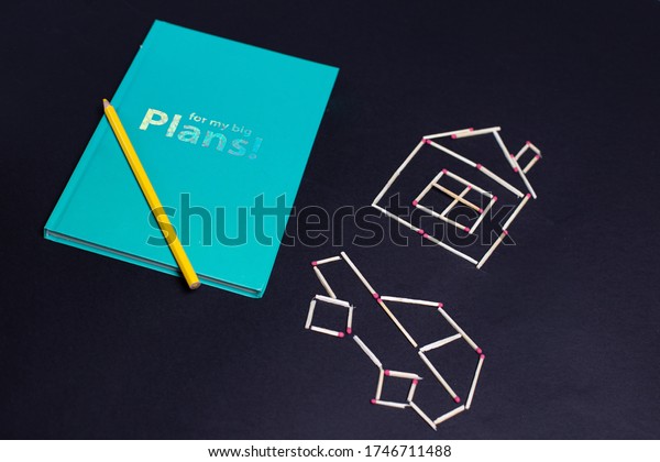Planner notebook for kids with house and car made of\
matches 