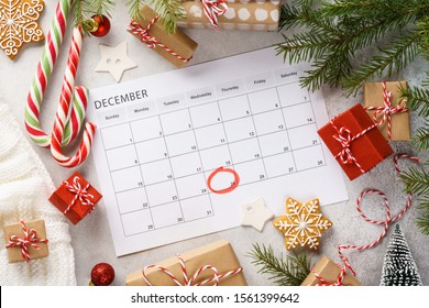 Planner page with Christmas gift boxes and decoration around. 25th of December marked with red circle on calendar. Xmas preparation concept. - Powered by Shutterstock