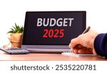 Planning budget 2025 new year symbol. Concept words Budget 2025 on beautiful black tablet. Beautiful white background. Businessman hand. Business budget 2025 new year concept. Copy space.