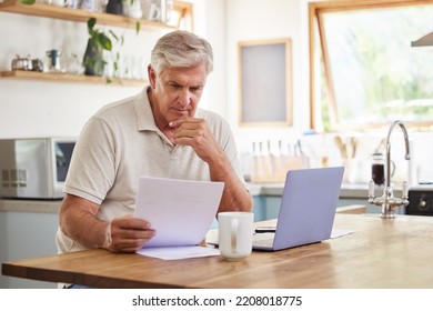 Planning, documents and finance with elderly man on laptop in a kitchen, reading retirement and savings plan in his home. thinking, mortgage and investment paperwork with retired male contemplating - Powered by Shutterstock