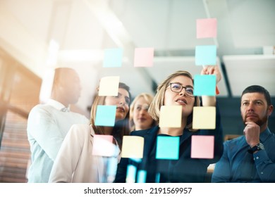 Planning, innovation and vision business meeting in a modern office, working on a business marketing strategy. Group, team or staff discussing with sticky notes a schedule for future project - Shutterstock ID 2191569957