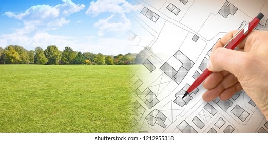 Planning A New City - Concept Image With Hand Drawing An Imaginary Cadastral Map Of Territory With Buildings, Fields And Roads Against A Green Area