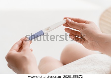 Planning parenting. Future mother. Woman holding negative positive pregnancy test. Adoption, abortion invitro fertilization concept