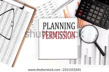 PLANNING PERMISSION text on a notebook with clipboard and calculator on a chart background