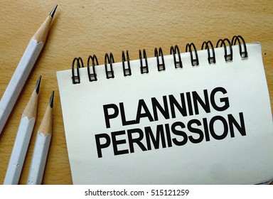 Planning Permission text written on a notebook with pencils