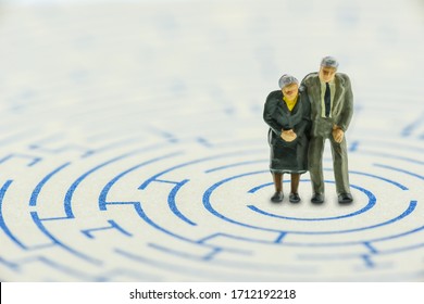 Planning For Retirement / Avoid Top Concerns Or Issues For Retiree, Financial Concept : Senior Couple In A Complex Maze Try To Find The Way To Handle Or Escape From Problems Of Unexpected Longer Life