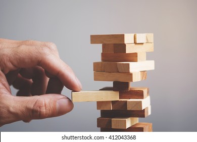 Planning, risk and strategy in business, businessman and engineer gambling placing wooden block on a tower. - Powered by Shutterstock