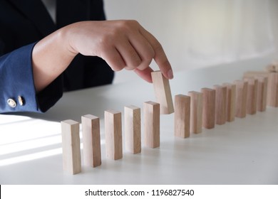 Planning risk and strategy in businessman gambling placing wooden blocks stag. Business concept for growth and success process. - Shutterstock ID 1196827540