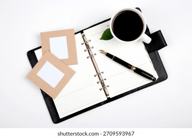 Planning session with coffee, note pad, and empty photo frames for creative ideas