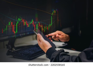 planning and strategy stock market hands of a businessman working with a smartphone Technical price charts and indicators red and green candlestick chart and mobile screen backgrounds for trading 