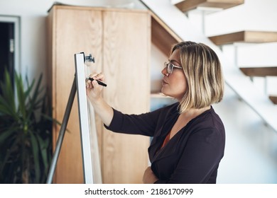 Planning Strategy, Thinking And Writing Ideas On Whiteboard To Market, Promote And Advertise New Startup Company. Confident, Serious And Assertive Business Woman, Manager And Boss Finding A Solution