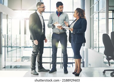 Planning, talking and professional group of business people preparing for a meeting on a digital tablet in a modern office. Diverse team discussing creative plan and strategy for a proposal - Shutterstock ID 2188929603