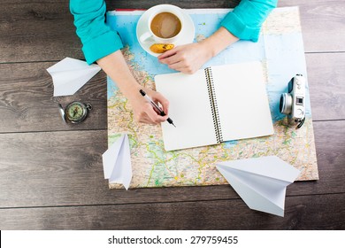 planning travel for a cup of coffee. Empty space in a notebook for blog entries, you can place your text or information. Top view - Powered by Shutterstock