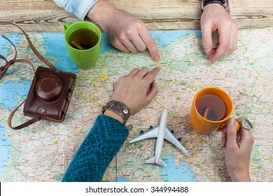 Planning A Trip To Berlin, Germany. Young Couple At The Table Over The Map. Top View