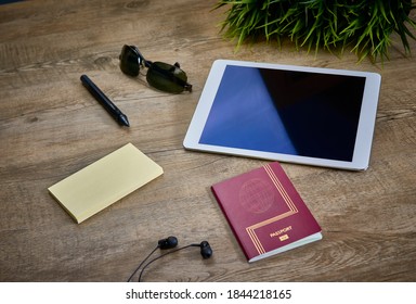 Planning a vacation trip with the passport, glasses, a tablet and other necessary equipment to enjoy - Powered by Shutterstock