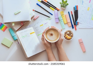 Planning the week. School schedule. Top view of a white table with stationery and hands with a cup of coffee. Student's workplace. 