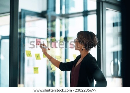 Planning, writing and business woman on glass moodboard for marketing ideas, brainstorming workflow or project. Professional worker or person, sticky notes and schedule, reminder or creative solution