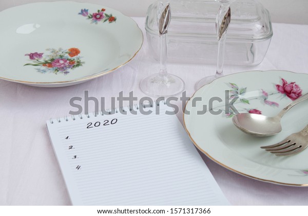 Plans for\
2020 write in notebook notebook lies on the table near are worth\
beautiful festive plates a fork and\
spoon