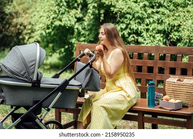 Plans And Diet For Breastfeeding Moms. Allergy In An Infant Child During Breastfeeding The Baby. Young Mom Eating Fruits While Walk With Newborn Baby In Stroller.