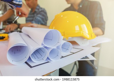 Plans and documents are placed on desks in the engineering team's office to prepare for the meeting of the designers, engineers and foreman teams to supervise the construction work as planned. - Shutterstock ID 1988115875