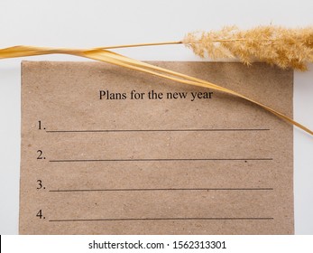 Plans for the new year. Craft leaf and dry ear. - Shutterstock ID 1562313301