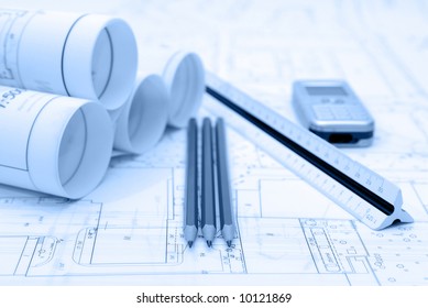 Plans And Office Utensils On Table