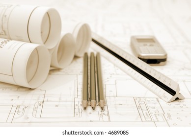 Plans And Office Utensils On The Table