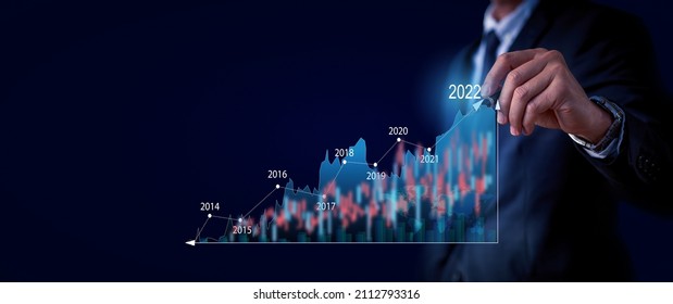 Plans and Visions for Next Year 2022.Businessman draws increase arrow graph corporate future growth year 2021 to 2022. Planning,opportunity, challenge and business strategy. New Goals,