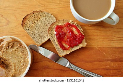 A Plant Based Breakfast Of Homemade Whole Grain Bread, Almond Butter, Strawberry Jam, And Organic Coffee